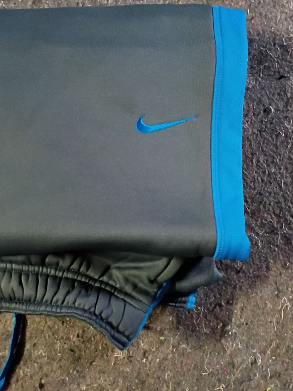 The image shows a pair of Blue Nike & Gray Therma-FIT  training pants featurin